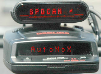 Escort Passport RedLine radar detector with Escort Passport SC55 alerts to red light camera ahead.